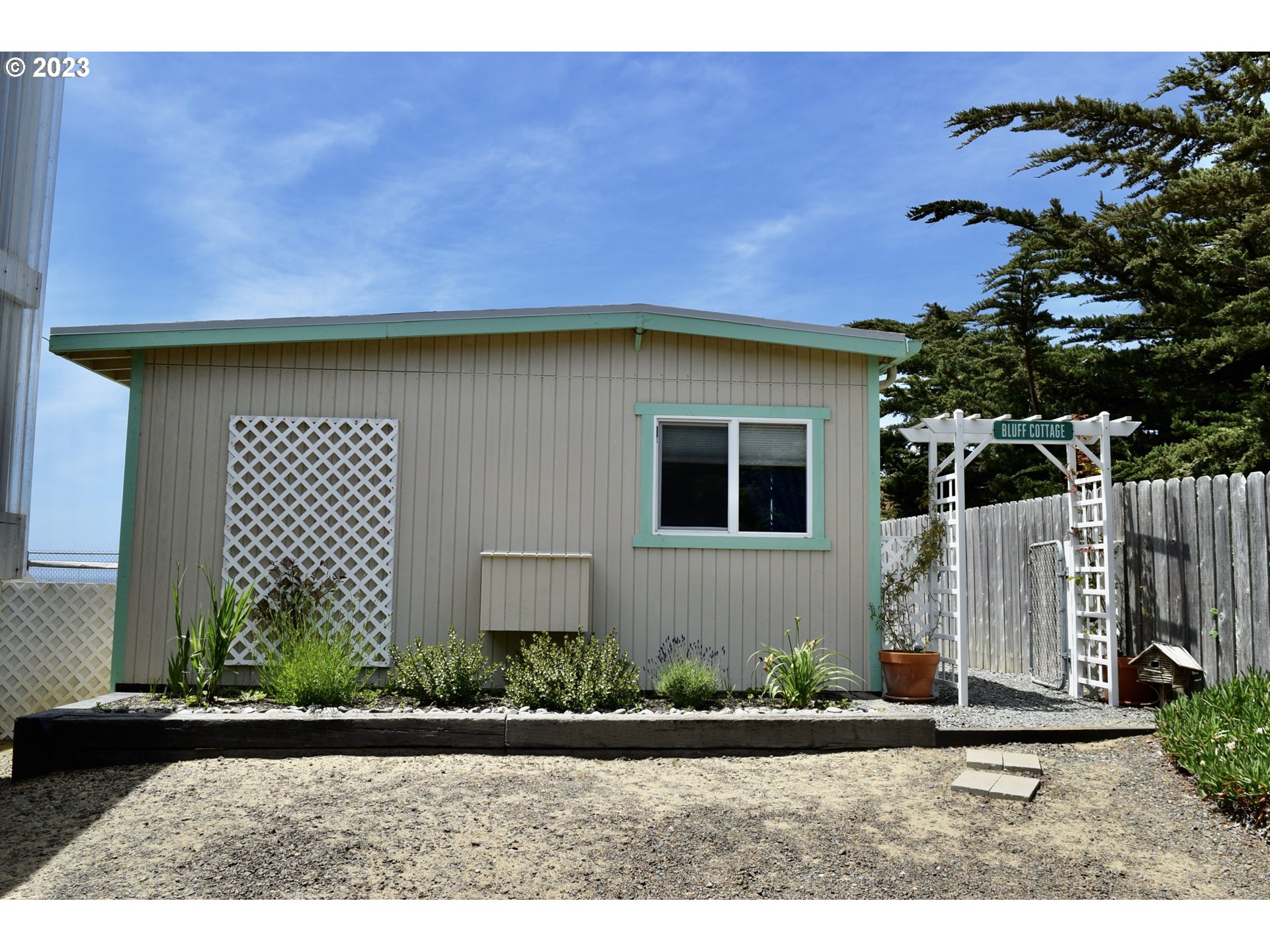 33074 Nesika Road Gold Beach, OR 97444 - Photo 29 of 40 a front view of a house with a yard