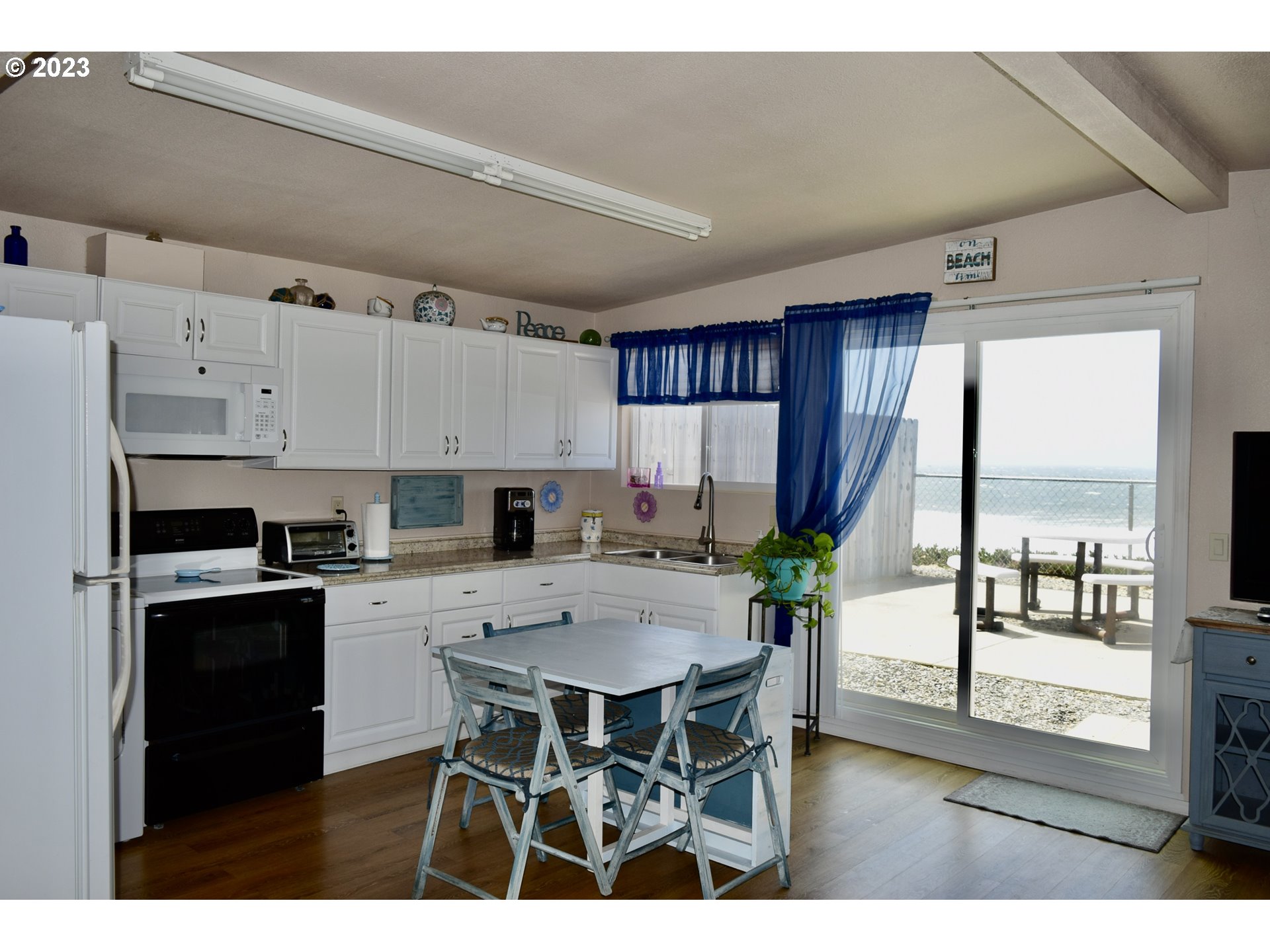 33074 Nesika Road Gold Beach, OR 97444 - Photo 31 of 40 a view of kitchen with cabinets and wooden floor