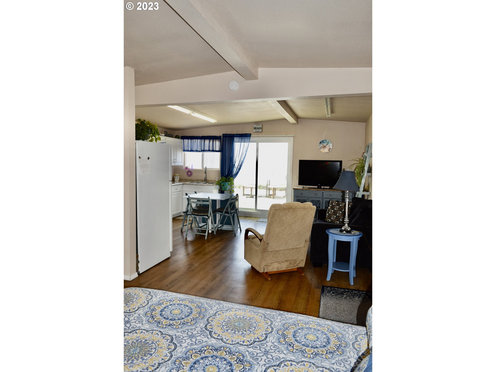 33074 Nesika Road Gold Beach, OR 97444 - Photo 34 of 40 a living room with furniture and a flat screen tv