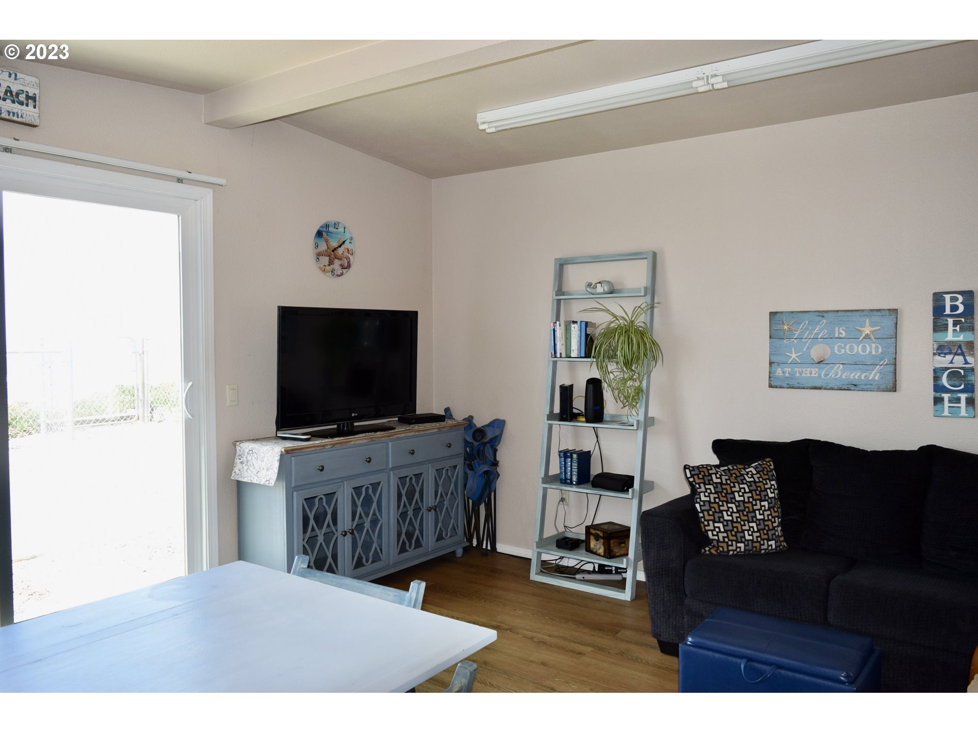 33074 Nesika Road Gold Beach, OR 97444 - Photo 35 of 40 a living room with furniture and a flat screen tv