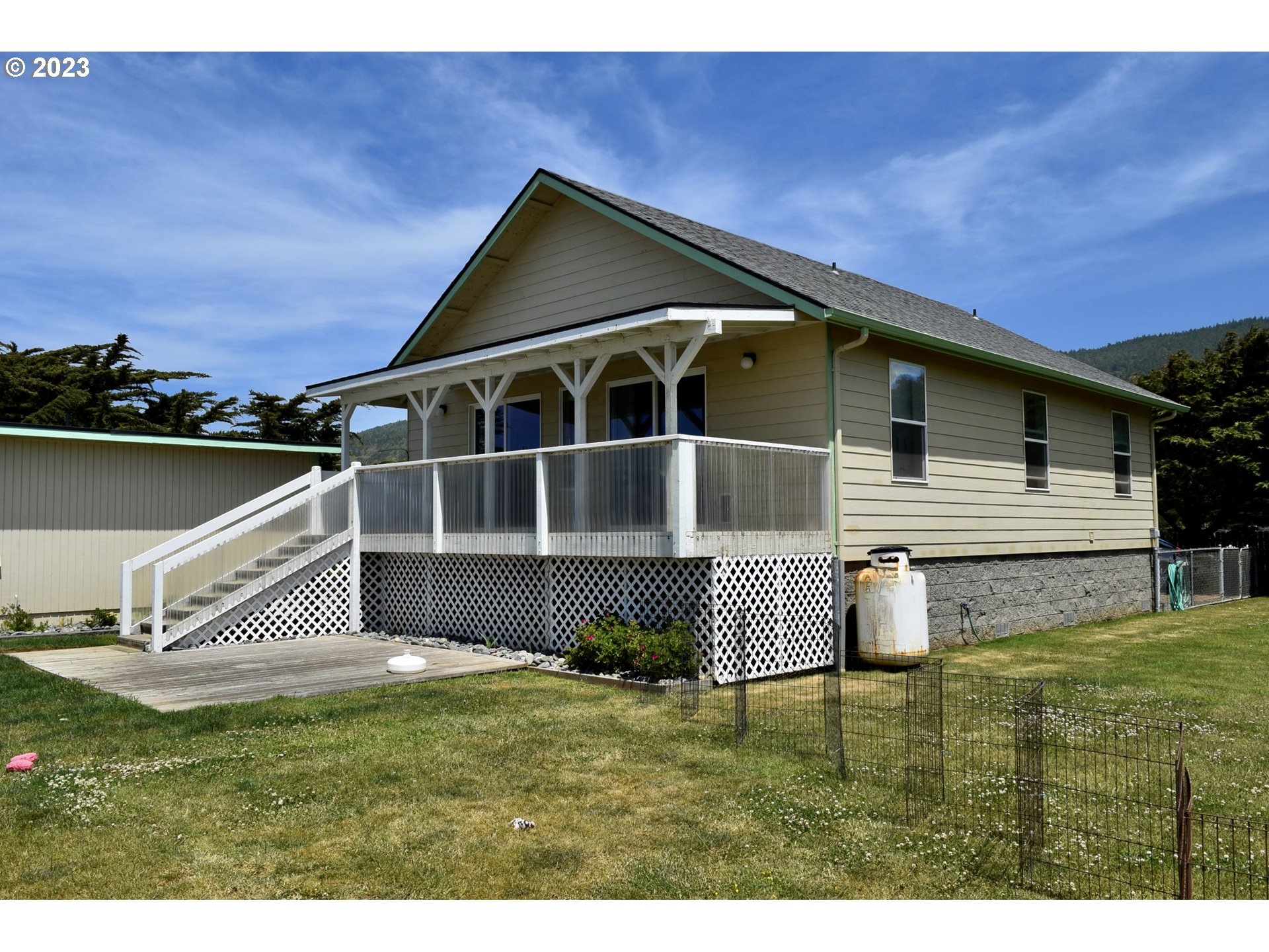 33074 Nesika Road Gold Beach, OR 97444 - Photo 5 of 40 a front view of a house with garden