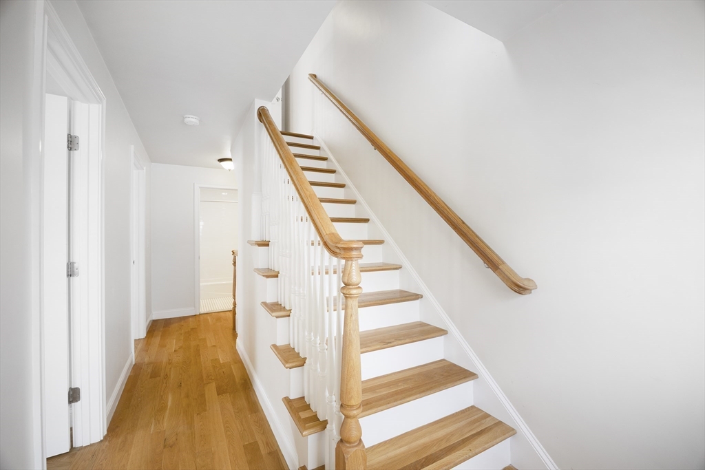 48 Spruce Street, Unit 1 Winchester, MA 01890 - Photo 16 of 29 a view of staircase with white walls