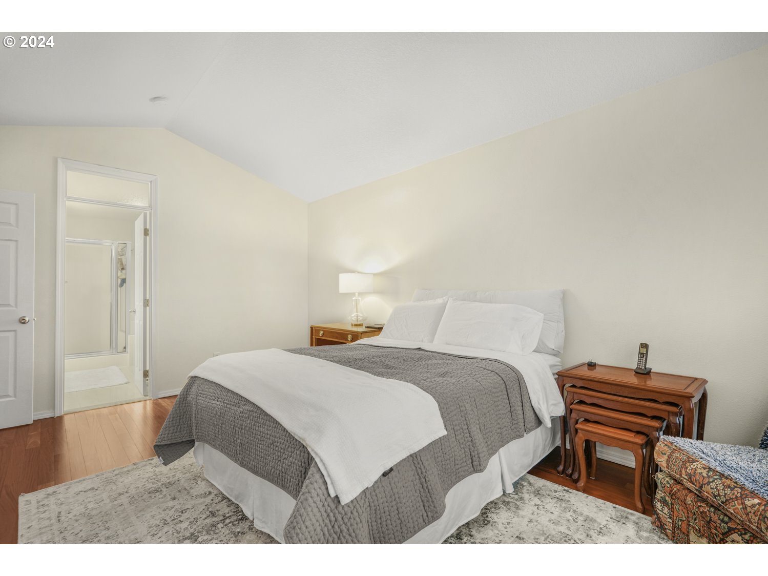 4412 Northwest 12th Avenue Camas, WA 98607 - Photo 15 of 33 a bedroom with a bed table chair and a wall painting