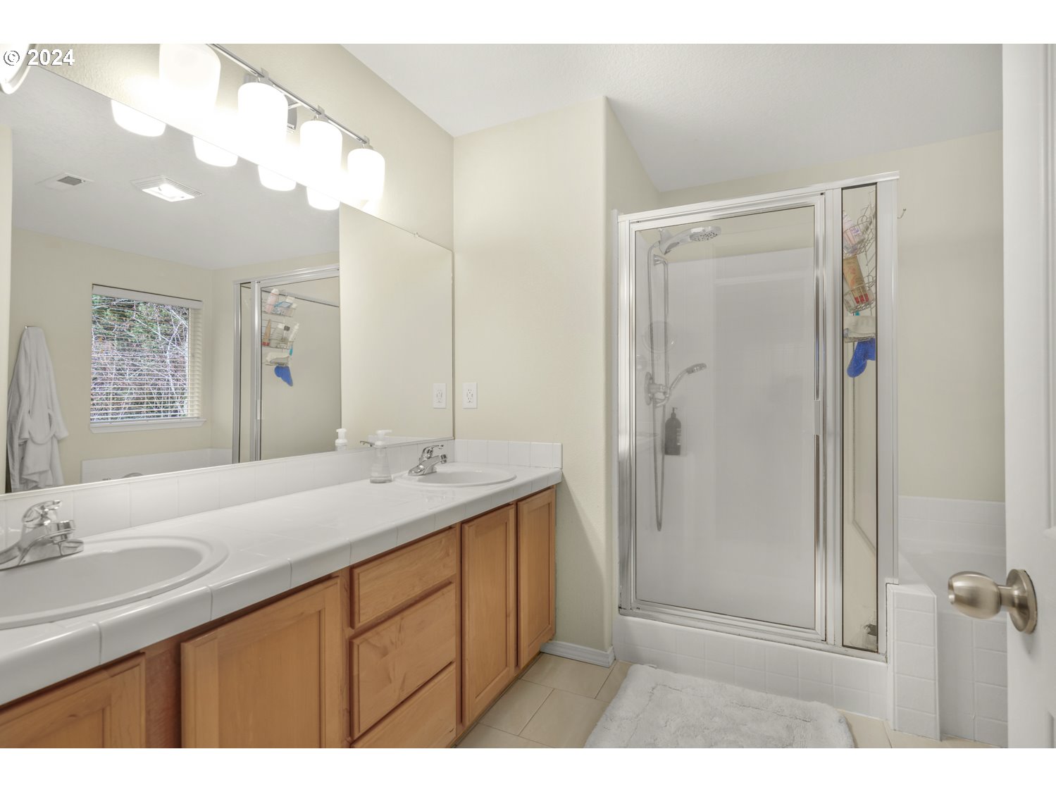 4412 Northwest 12th Avenue Camas, WA 98607 - Photo 16 of 33 a bathroom with a sink a shower and a mirror
