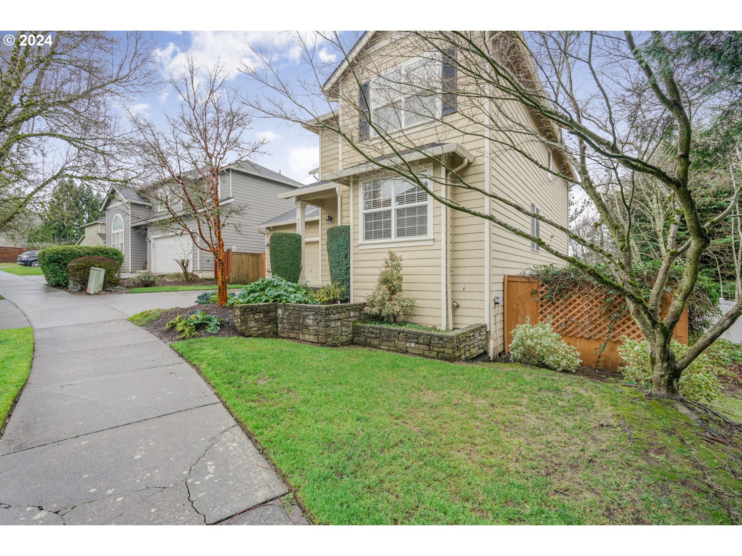 4412 Northwest 12th Avenue Camas, WA 98607 - Photo 31 of 33 a view of a white house next to a yard with big trees