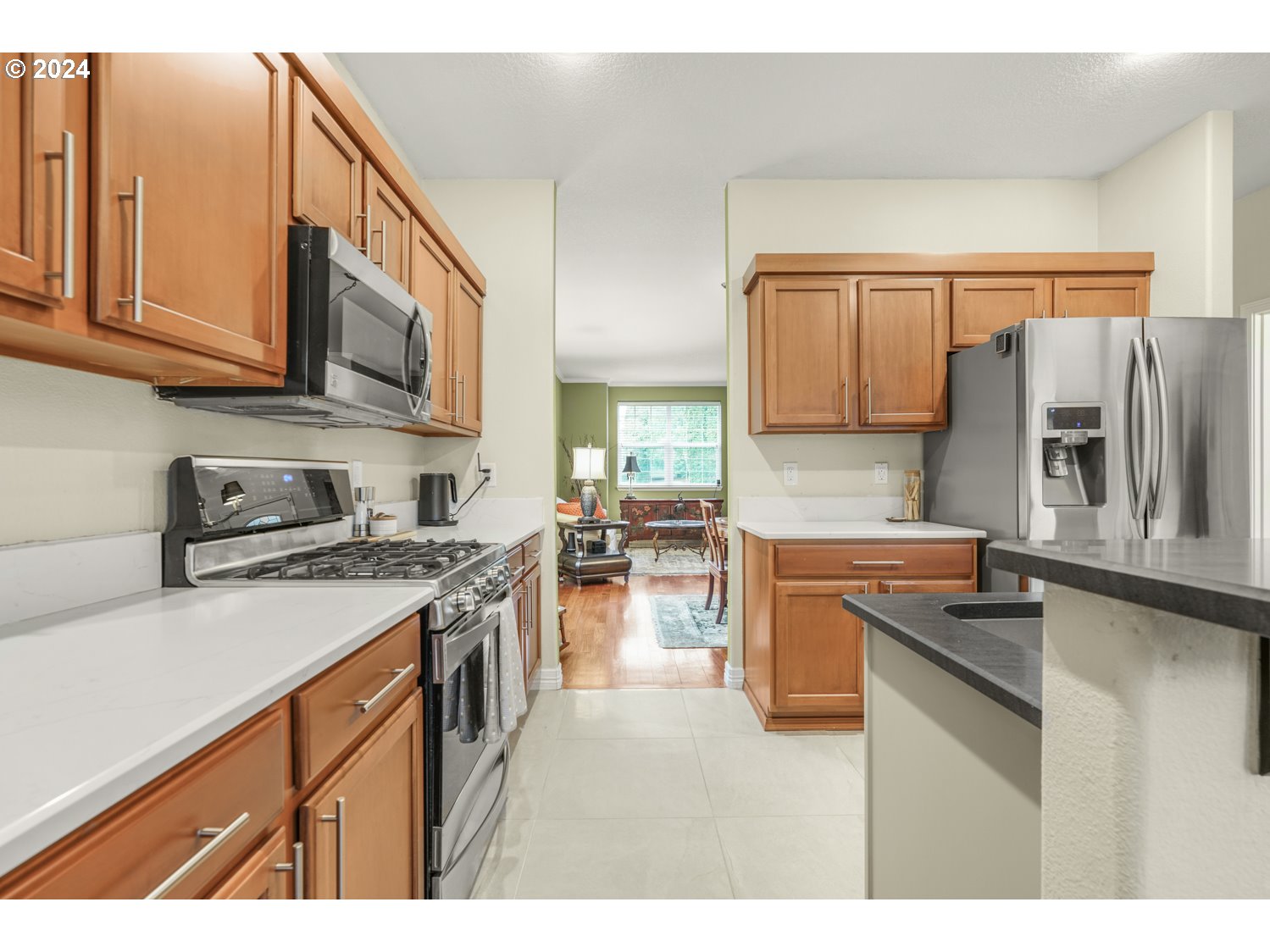 4412 Northwest 12th Avenue Camas, WA 98607 - Photo 7 of 33 a kitchen with stainless steel appliances granite countertop a stove top oven a sink a counter space and cabinets