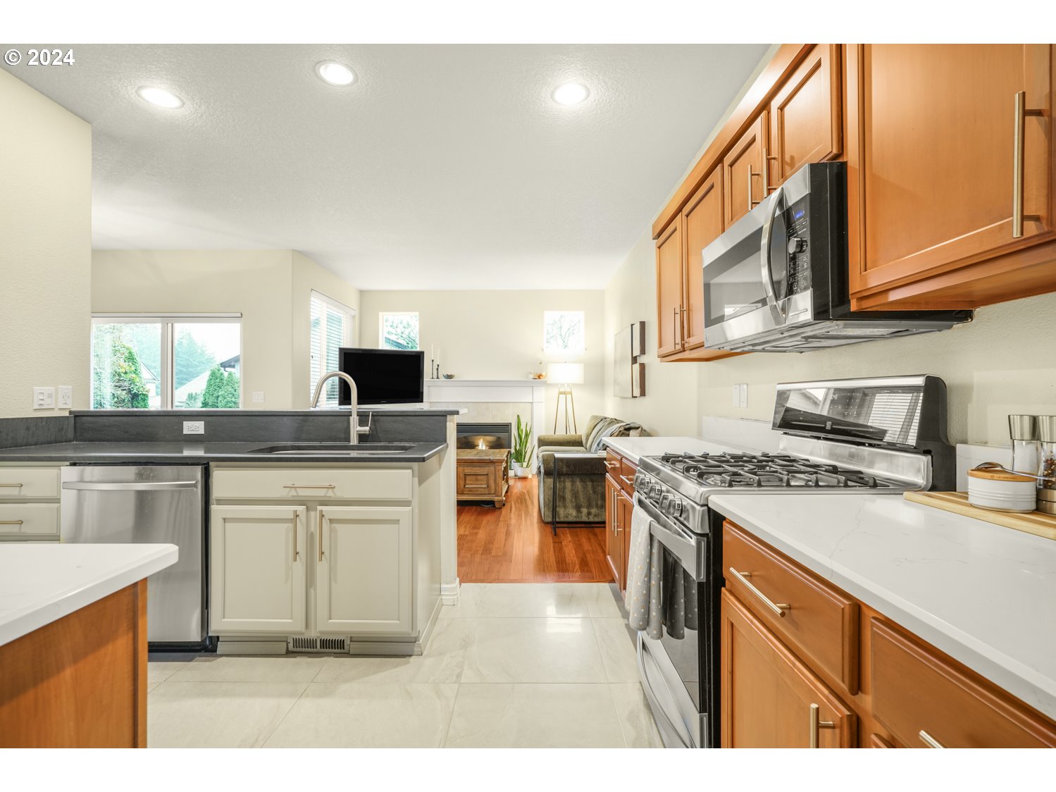 4412 Northwest 12th Avenue Camas, WA 98607 - Photo 8 of 33 a kitchen with stainless steel appliances granite countertop a stove top oven a sink dishwasher and a refrigerator with wooden floor