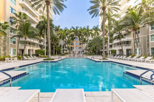 a swimming pool with outdoor seating and yard