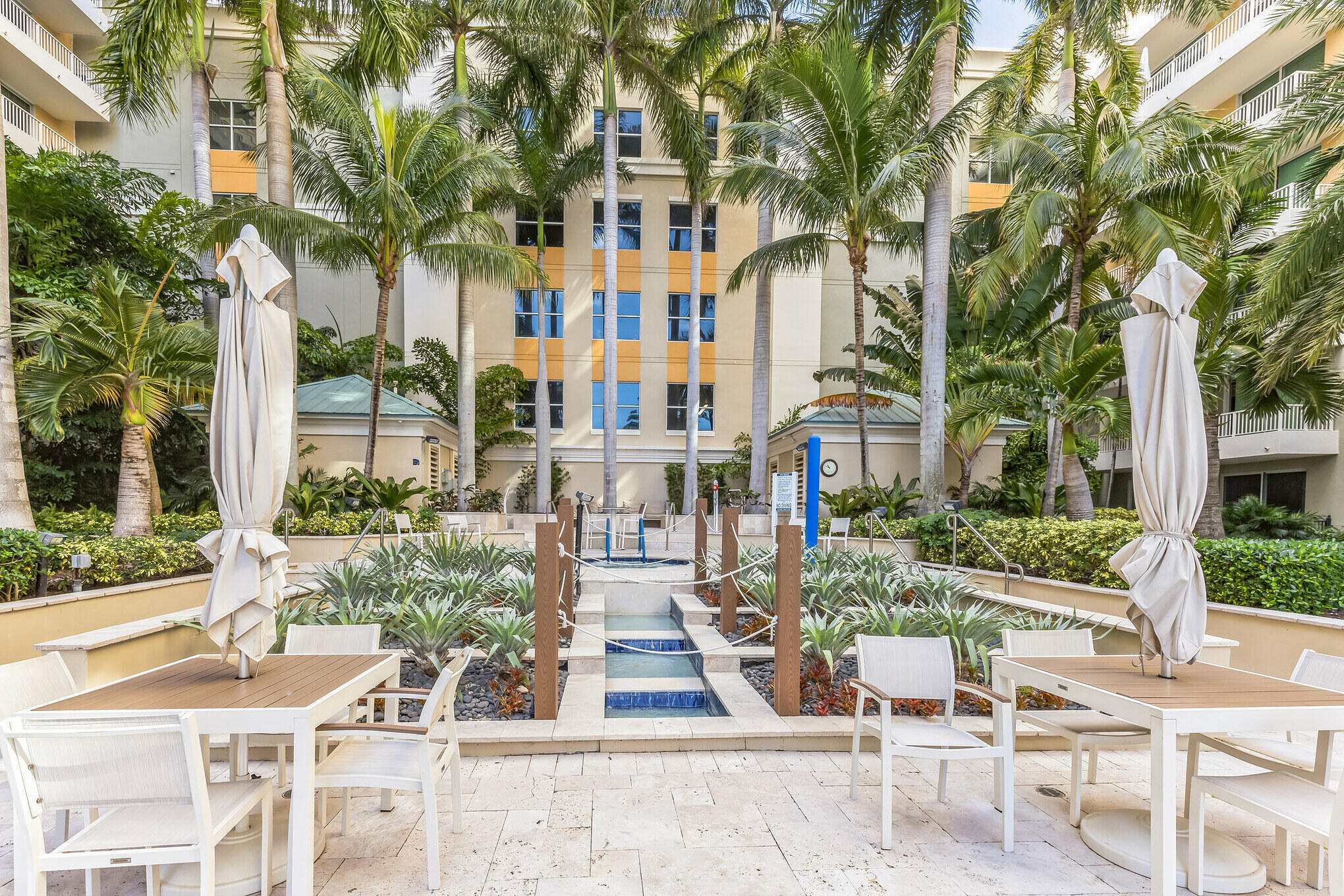 700 East Boynton Beach Boulevard, Unit 511 Boynton Beach, FL 33435 - Photo 21 of 37 front view of a building with a garden and plants