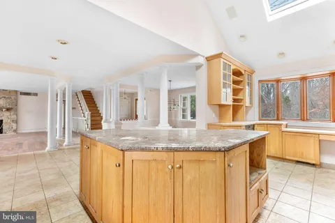 a kitchen with granite countertop a sink and a stove