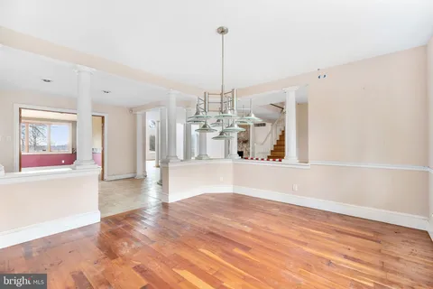 a view of a kitchen with microwave and windows