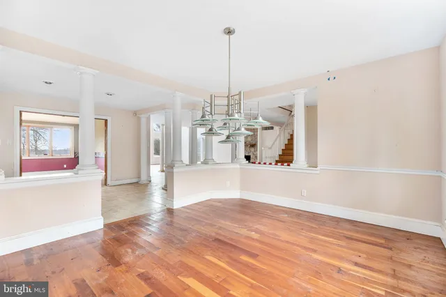 a view of a kitchen with microwave and windows