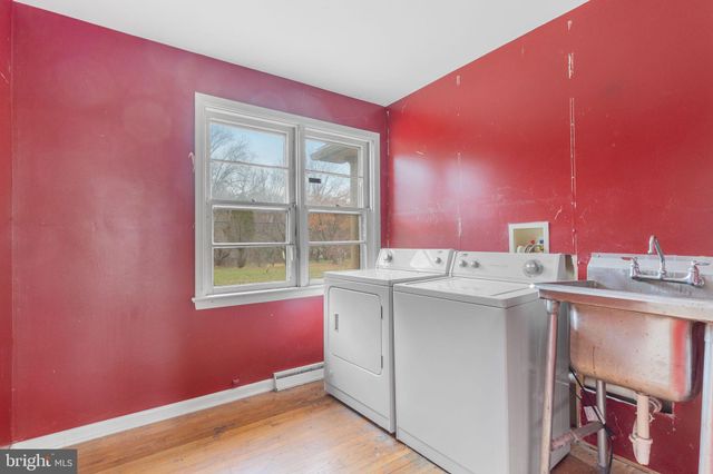 a view of kitchen with stainless steel appliances granite countertop a sink and dishwasher with wooden floor
