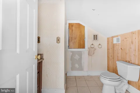a view of a livingroom with an empty space and a floor to ceiling window