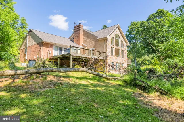 an aerial view of a house with a yard and garden