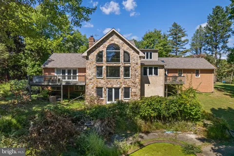 an aerial view of a house with a yard balcony