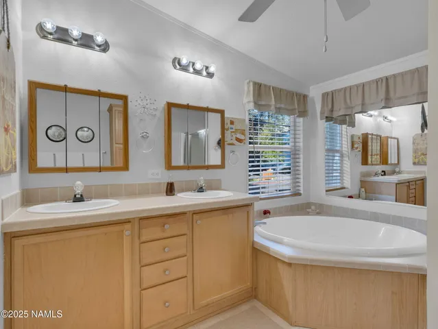 a bathroom with a tub sink and mirror