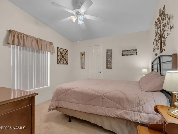 a bedroom with a bed dresser and a window
