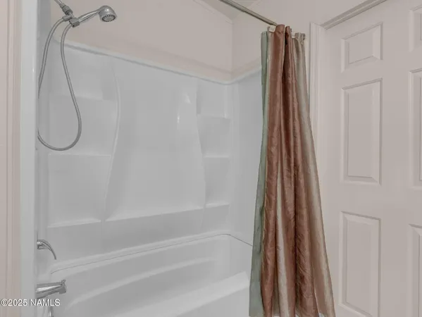 a bathroom with a shower and a bath tub