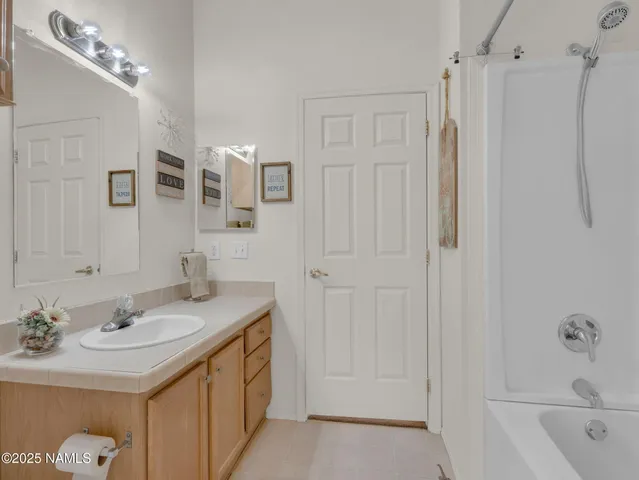 a bathroom with a sink vanity tub and shower