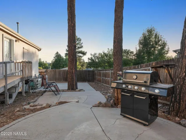 a view of a patio with a table and chairs