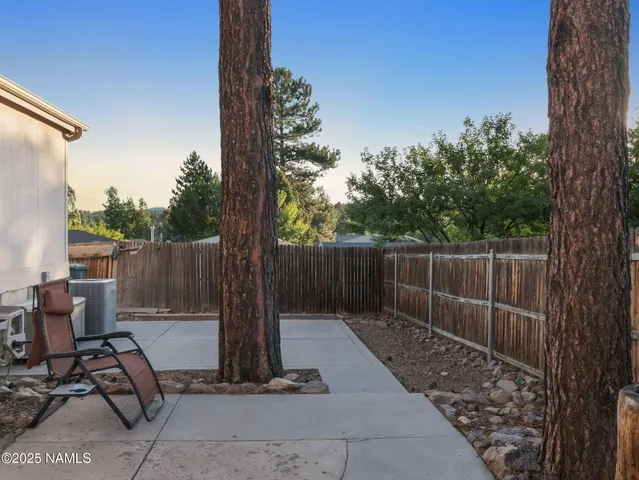 a view of backyard with tub and trees