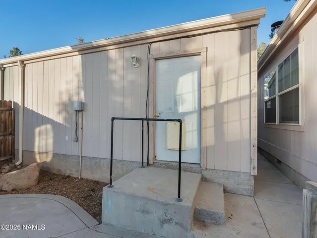 a bathroom with a glass door shower and a sink