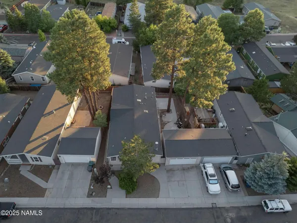 an aerial view of a house with yard and garage