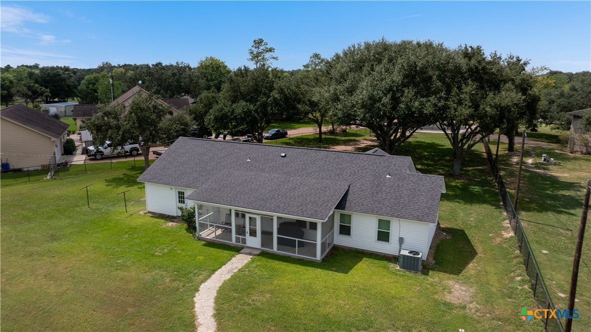 a aerial view of a house with swimming pool and a yard