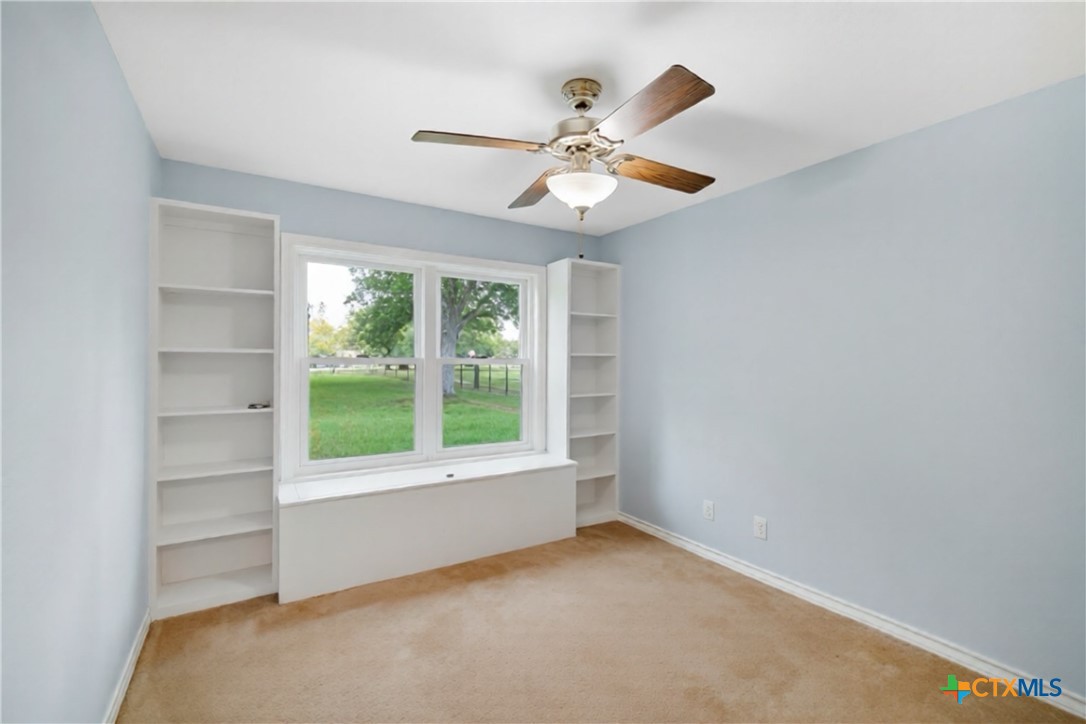 83 Lakeoak Victoria, TX 77905 - Photo 15 of 16 an empty room with windows and fan