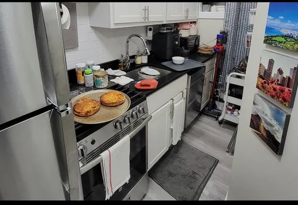 a view of living room with furniture and wooden floor