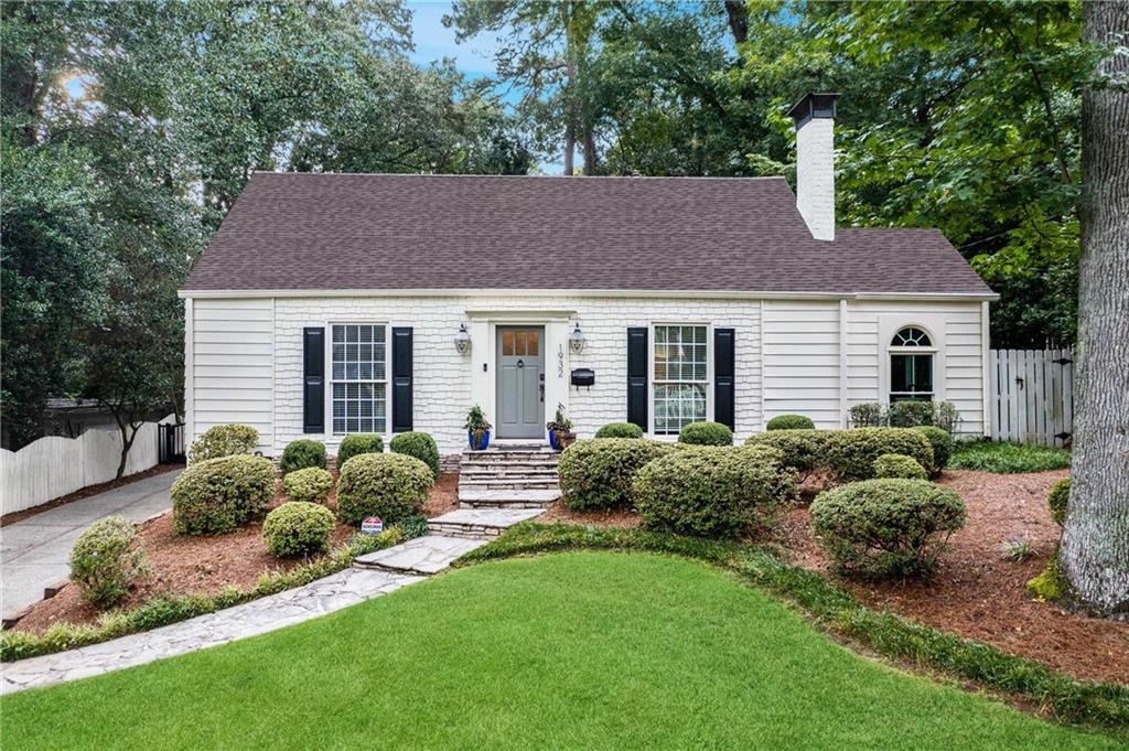 a house with green field in front of it