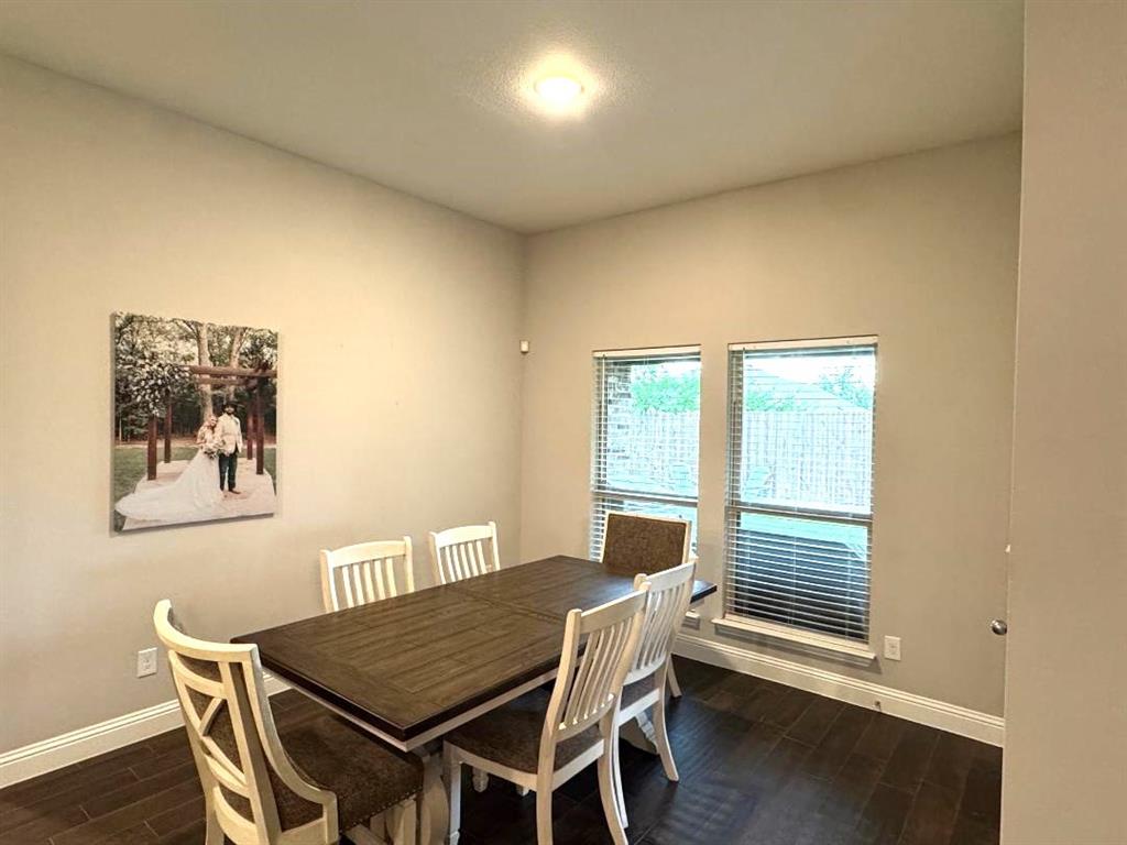 1455 Radecke Road Krum, TX 76249 - Photo 6 of 18 a view of a dining room with furniture and wooden floor
