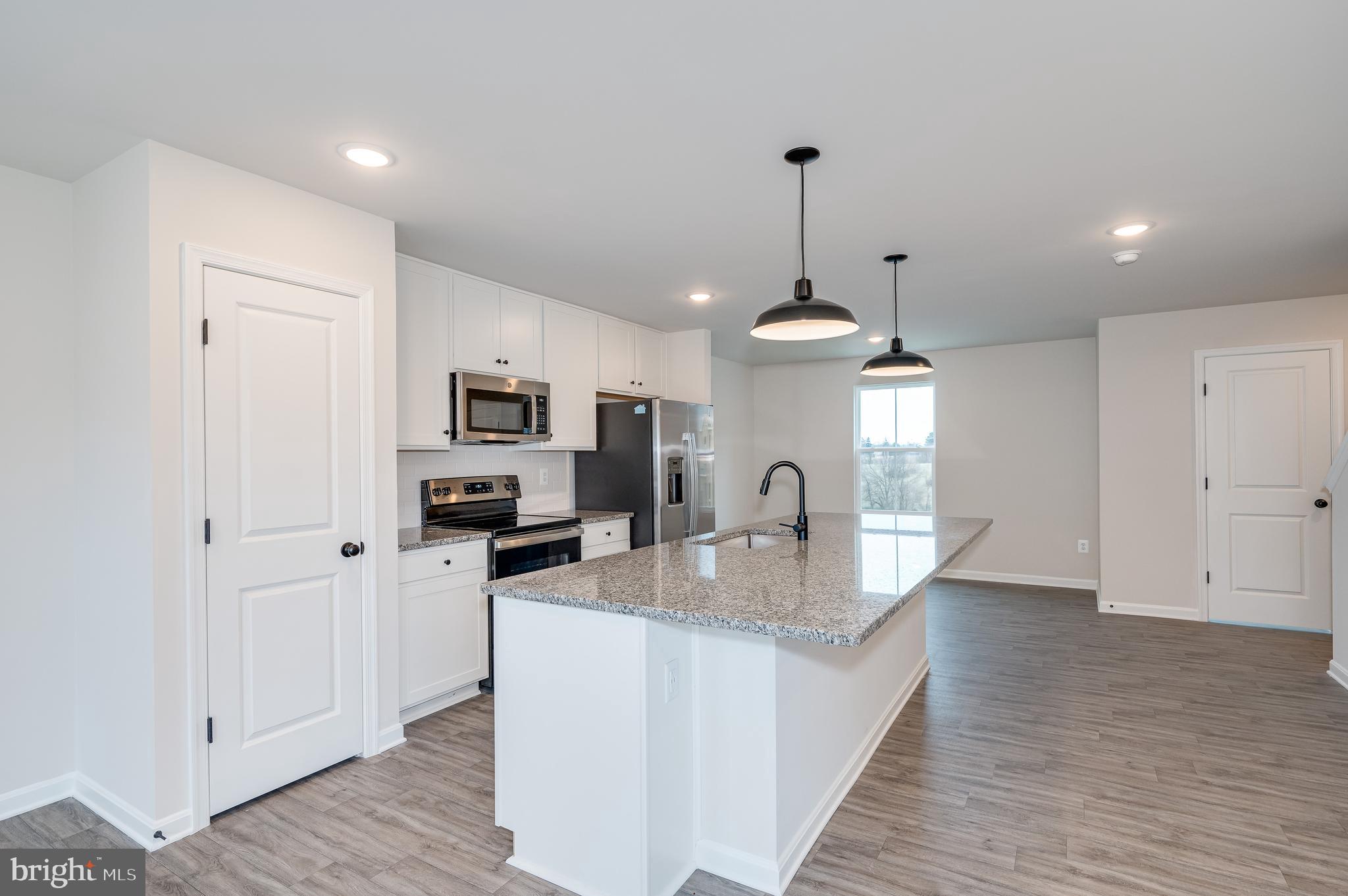 164 Rabbit Road Hedgesville, WV 25427 - Photo 23 of 41 a kitchen with stainless steel appliances granite countertop a sink refrigerator and cabinets