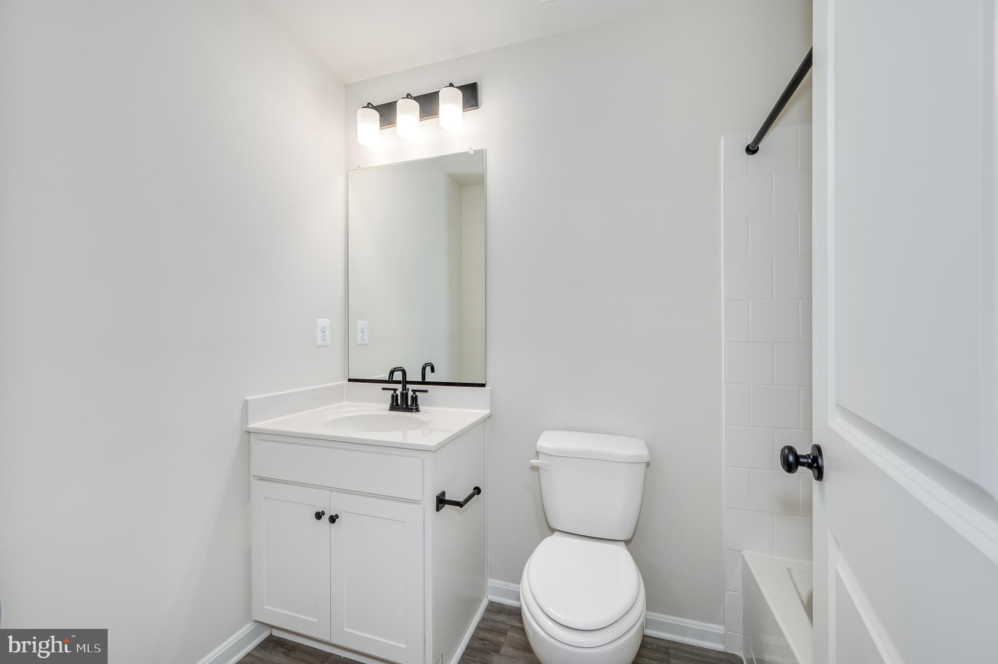 164 Rabbit Road Hedgesville, WV 25427 - Photo 36 of 41 a bathroom with a toilet sink and mirror