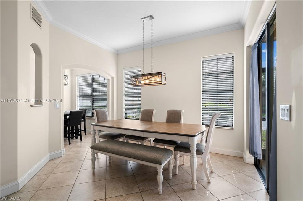 1276 Strada Milan Lane, Unit 2 Naples, FL 34105 - Photo 11 of 36 a dining room with furniture and window