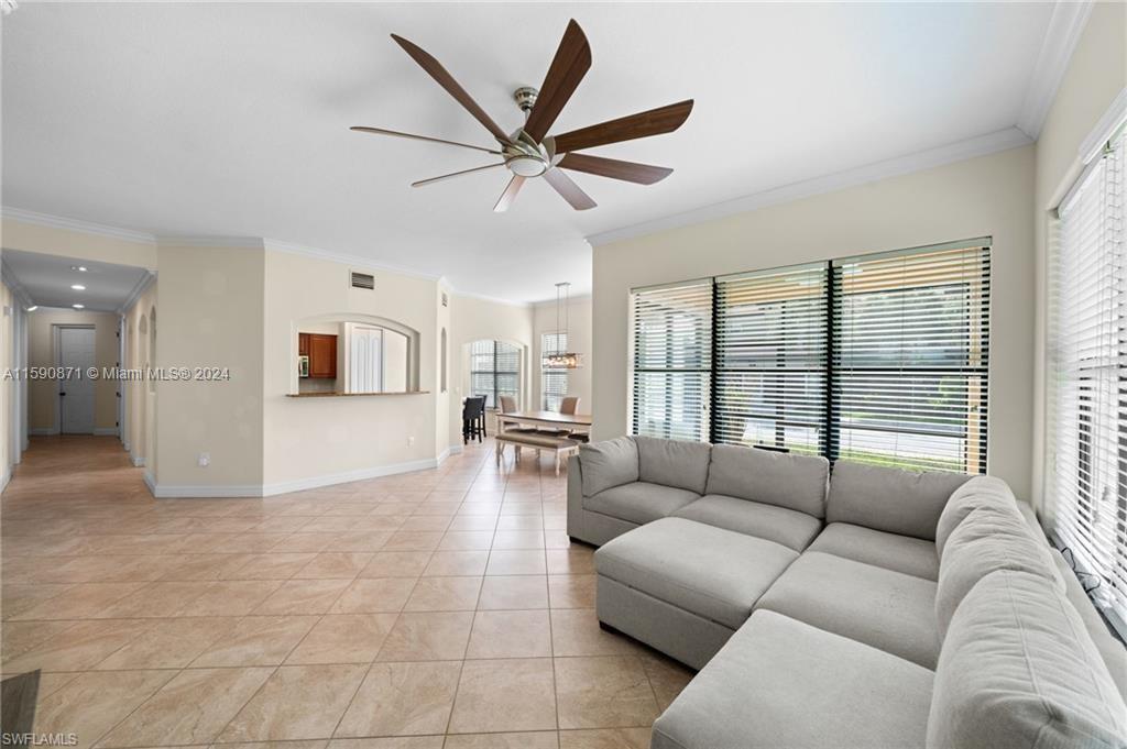 1276 Strada Milan Lane, Unit 2 Naples, FL 34105 - Photo 14 of 36 a living room with furniture and a large window
