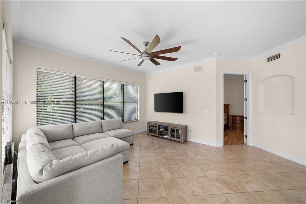 1276 Strada Milan Lane, Unit 2 Naples, FL 34105 - Photo 16 of 36 a living room with furniture and a flat screen tv