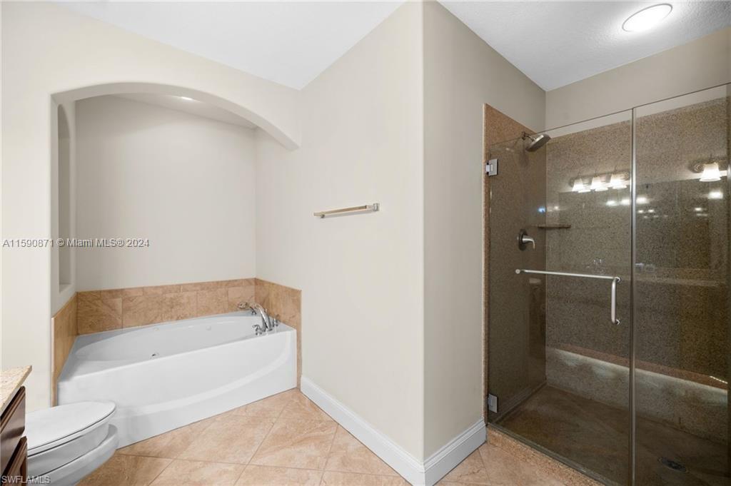 1276 Strada Milan Lane, Unit 2 Naples, FL 34105 - Photo 20 of 36 a bathroom with a tub and shower
