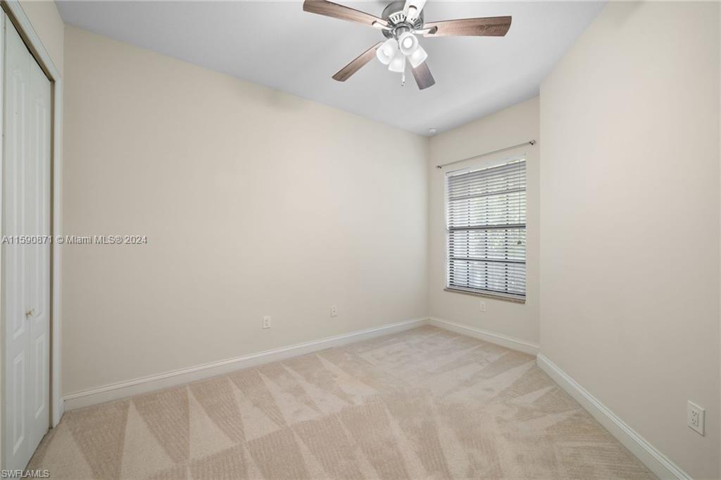1276 Strada Milan Lane, Unit 2 Naples, FL 34105 - Photo 22 of 36 an empty room with windows and fan