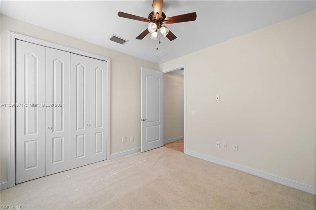1276 Strada Milan Lane, Unit 2 Naples, FL 34105 - Photo 26 of 36 an empty room with windows and fan