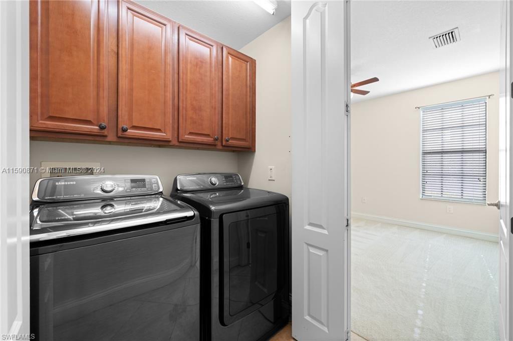 1276 Strada Milan Lane, Unit 2 Naples, FL 34105 - Photo 27 of 36 a utility room with stainless steel appliances granite countertop a sink and a washer dryer
