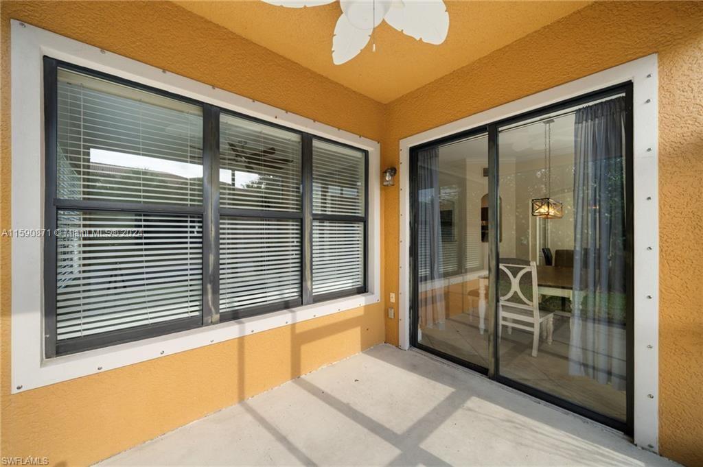 1276 Strada Milan Lane, Unit 2 Naples, FL 34105 - Photo 30 of 36 a view of a balcony with a large window and an outdoor space