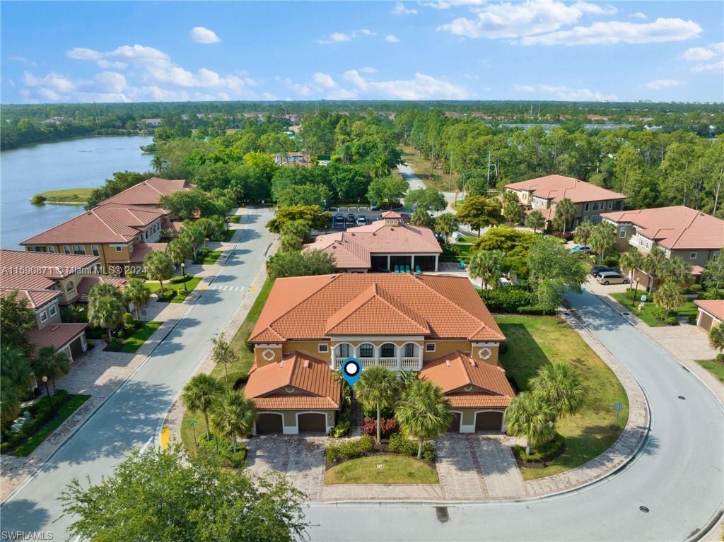 1276 Strada Milan Lane, Unit 2 Naples, FL 34105 - Photo 31 of 36 an aerial view of a house with a garden and lake view