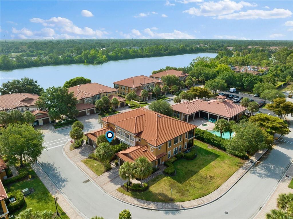1276 Strada Milan Lane, Unit 2 Naples, FL 34105 - Photo 32 of 36 an aerial view of a house with a garden and lake view