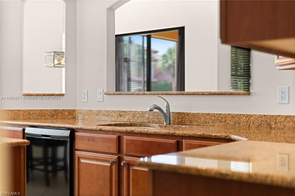 1276 Strada Milan Lane, Unit 2 Naples, FL 34105 - Photo 5 of 36 a kitchen with granite countertop a sink and a window
