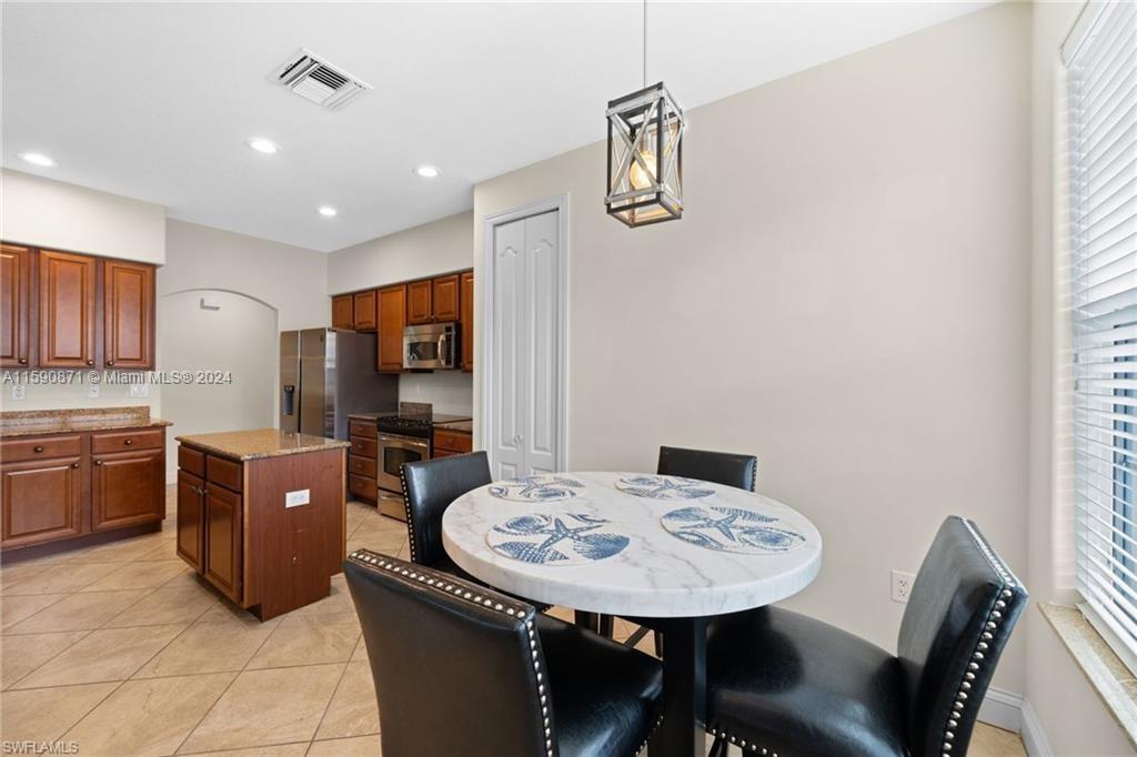 1276 Strada Milan Lane, Unit 2 Naples, FL 34105 - Photo 8 of 36 a view of a dining room with furniture