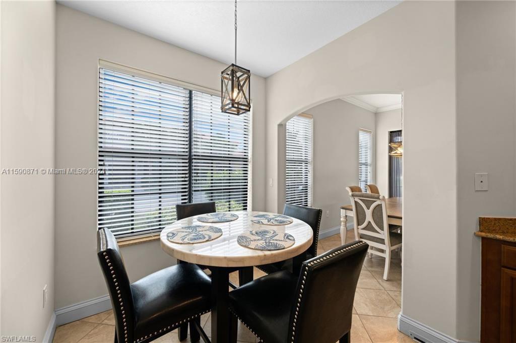 1276 Strada Milan Lane, Unit 2 Naples, FL 34105 - Photo 9 of 36 a view of a dining room with furniture and window
