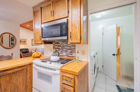 a bathroom with a sink a stove and a mirror