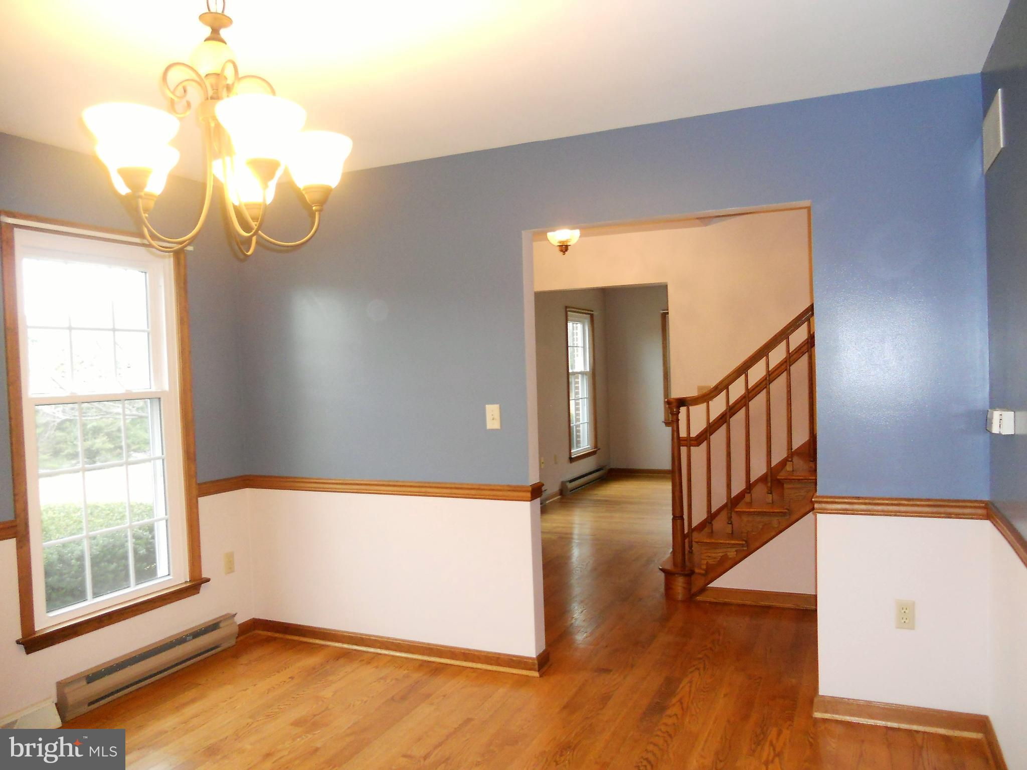 1755 Manchester Road Westminster, MD 21157 - Photo 5 of 38 Large dining room has wooden floors, chair railing